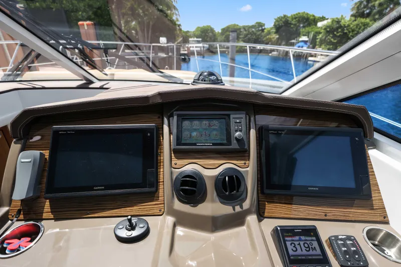 Slide: The Image of Helm of 2016 Cruisers Yachts 45 Cantius with navigation screens and controls. - 43