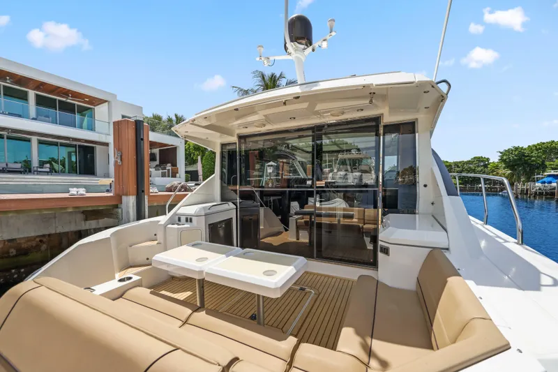 Slide: The Image of 2016 Cruisers Yachts 45 Cantius docked, featuring spacious outdoor seating and modern amenities. - 22