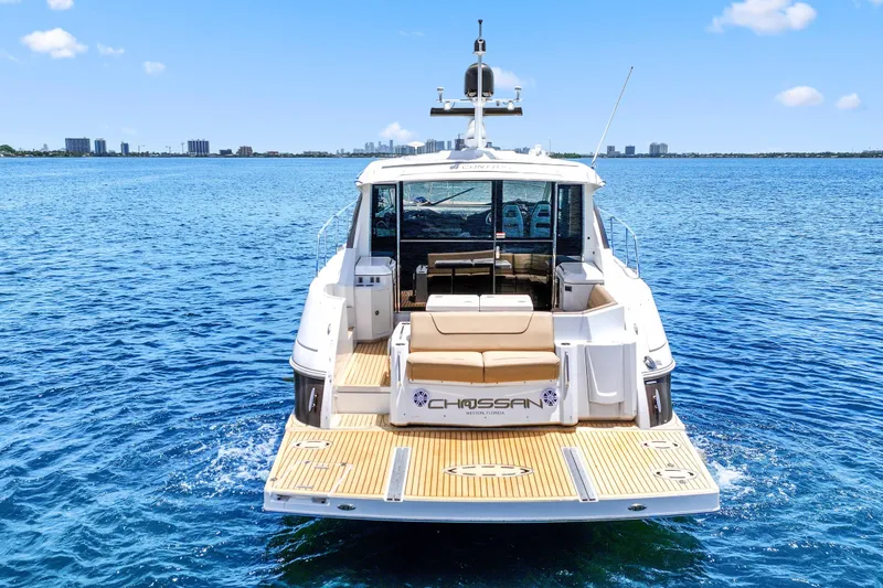 Slide: The Image of 2016 Cruisers Yachts 45 Cantius on open water, rear view with city skyline. - 4