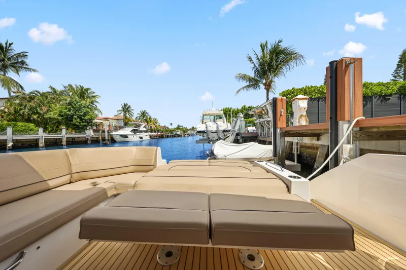 Slide: The Image of 2016 Cruisers Yachts 45 Cantius docked, featuring luxurious seating and scenic waterfront view. - 24