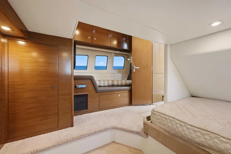 Slide: The Image of Luxurious interior of 2016 Cruisers Yachts 45 Cantius with wood finishes and cozy bedding. - 54