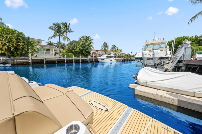 Slide: The Image of Luxury yachts docked in a tropical marina, featuring a 2016 Cruisers Yachts 45 Cantius. - 21
