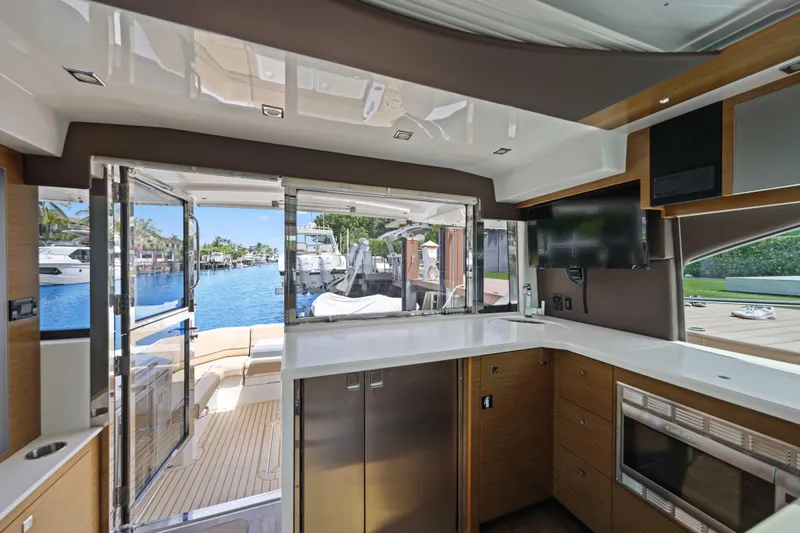 Slide: The Image of Luxurious interior of 2016 Cruisers Yachts 45 Cantius with modern kitchen and waterfront view. - 31