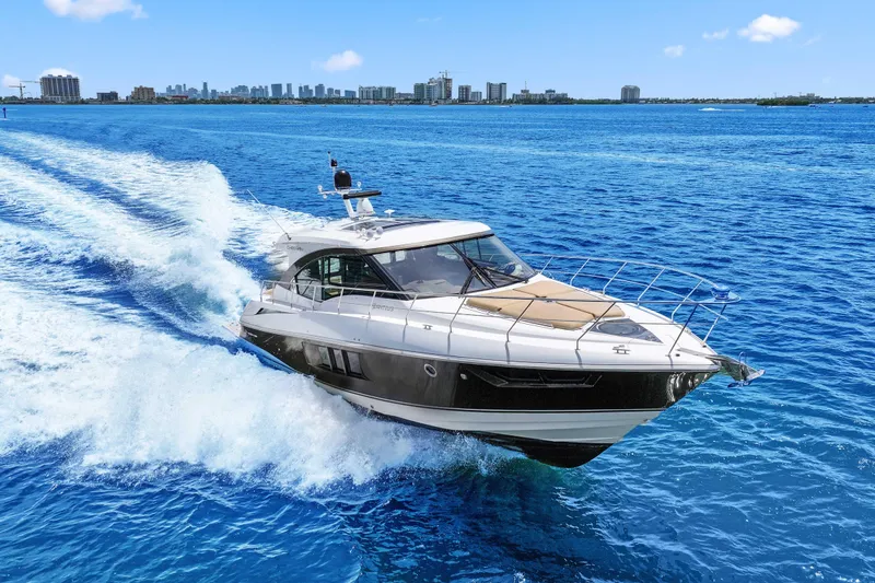 Slide: The Image of 2016 Cruisers Yachts 45 Cantius cruising on blue ocean near city skyline. - 12