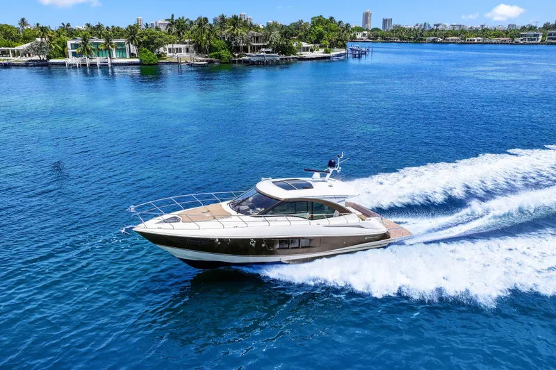 Slide: The Image of 2016 Cruisers Yachts 45 Cantius cruising on clear blue water near a tropical shoreline. - 11