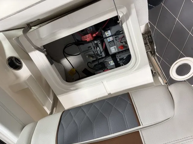 Slide: The Image of View of the battery compartment in a 2020 Cobia 240DC with cushioned seating. - 27