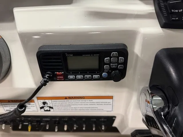 Slide: The Image of The image shows a radio and control elements on a 2020 Cobia 240DC boat. - 23
