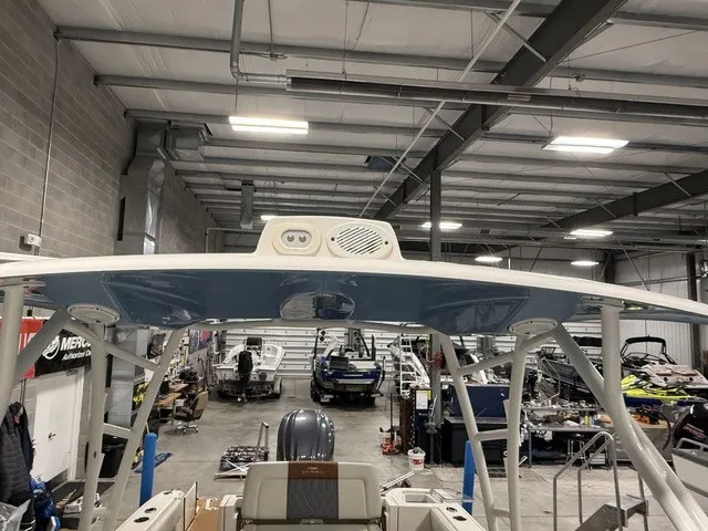 Slide: The Image of Interior view of a 2020 Cobia 240DC in a workshop with other boats. - 32
