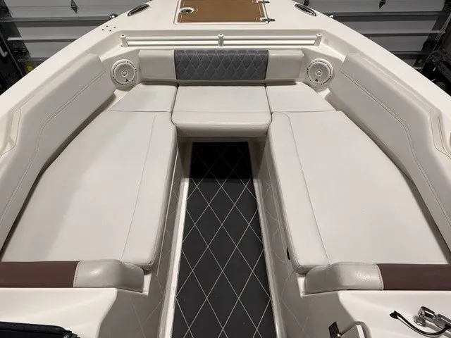 Slide: The Image of The image shows the bow area of a 2020 Cobia 240DC boat with cushioned seating. - 30