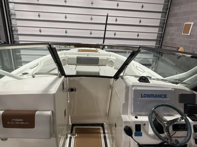 Slide: The Image of The image shows the cockpit of a 2020 Cobia 240DC boat with a Lowrance navigation system. - 29