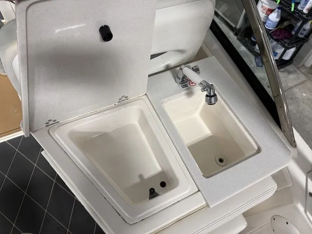 Slide: The Image of The image shows a white sink and basin on a boat. - 19