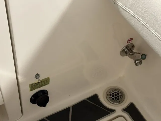 Slide: The Image of Close-up of a boat drain and faucet in the 2020 Cobia 240DC. - 36