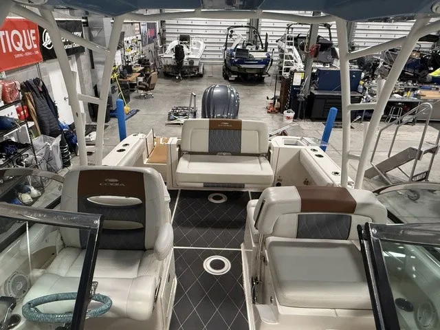 Slide: The Image of The image shows the cockpit of a 2020 Cobia 240DC boat in a workshop. - 35