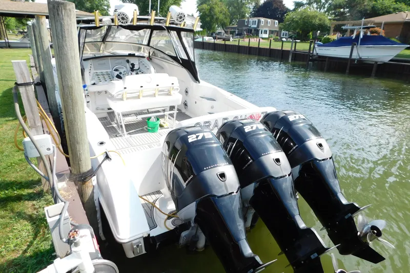 Slide: The Image of 2006 Fountain 38 LX boat with triple 275 horsepower engines docked by a canal. - 8