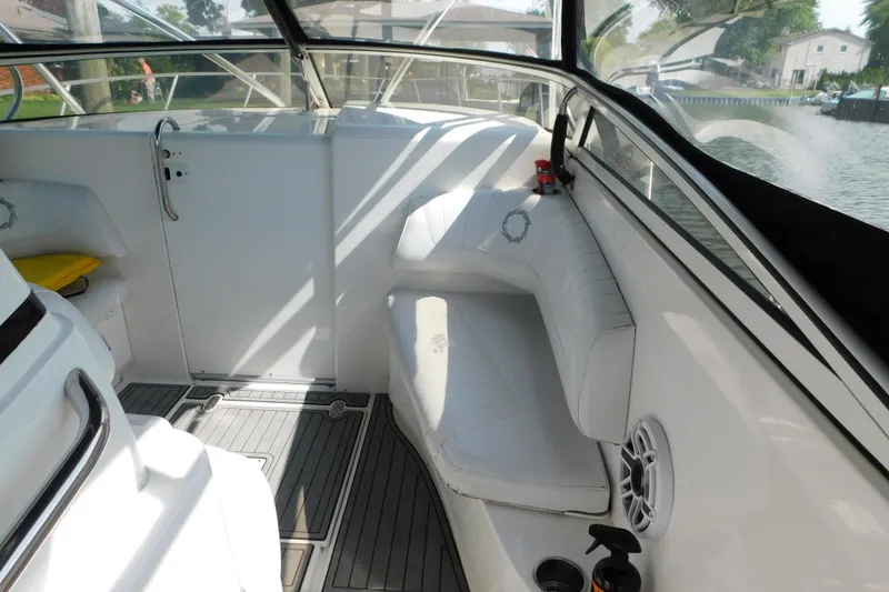 Slide: The Image of Interior of a 2006 Fountain 38 LX boat, featuring white seating and sleek design. - 31