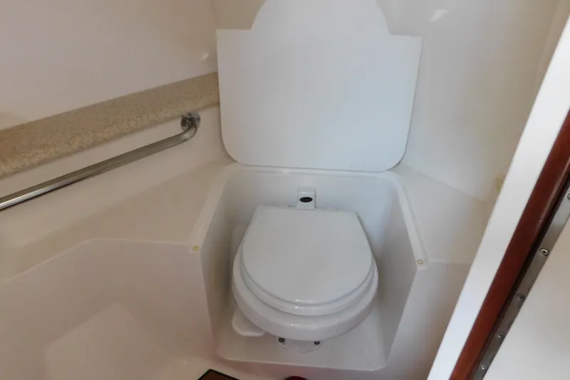 Slide: The Image of 2006 Fountain 38 LX boat bathroom with white toilet and grab rail. - 59