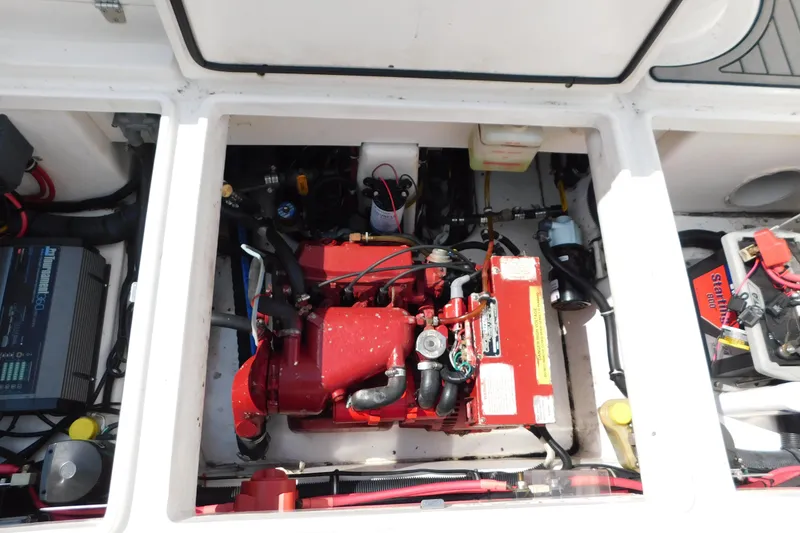 Slide: The Image of Engine compartment of a 2006 Fountain 38 LX boat, showcasing mechanical components and wiring. - 75
