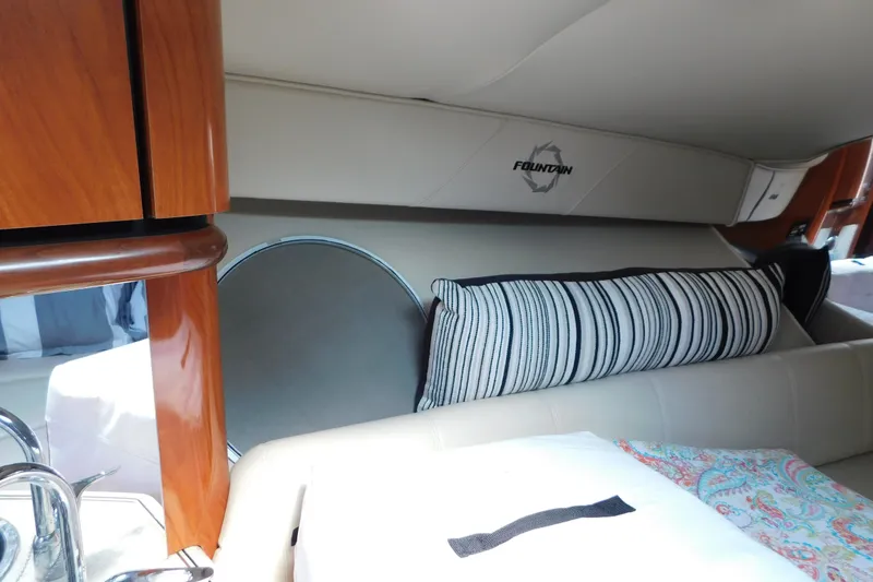 Slide: The Image of Interior of 2006 Fountain 38 LX boat with striped pillow and wood accents. - 44