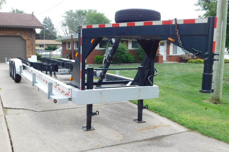 Slide: The Image of 2006 Fountain 38 LX boat trailer parked on a residential driveway. - 80