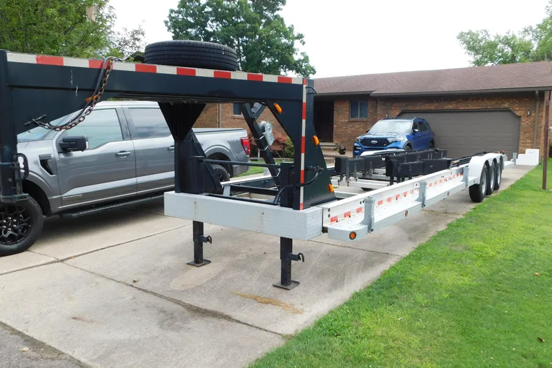 Slide: The Image of Trailer parked in driveway, suitable for 2006 Fountain 38 LX boat transport. - 86