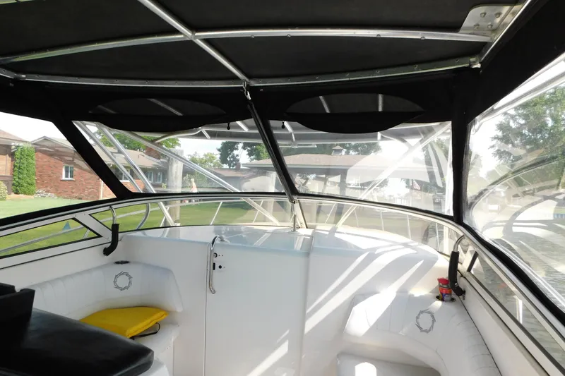 Slide: The Image of Interior view of a 2006 Fountain 38 LX boat with white seating and canopy. - 32