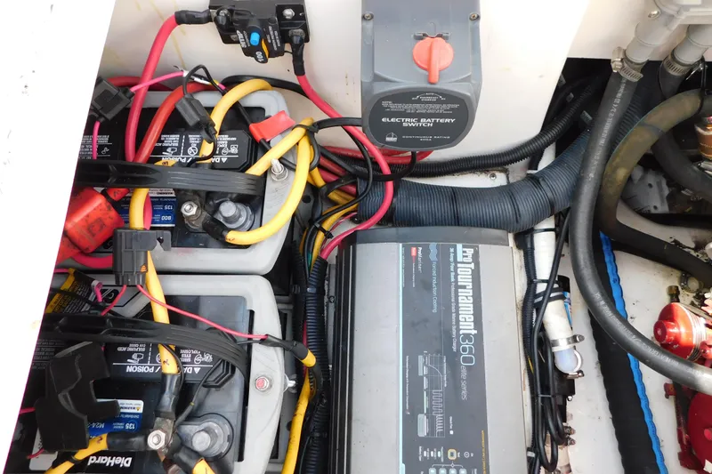 Slide: The Image of Engine compartment of a 2006 Fountain 38 LX boat with batteries and wiring. - 72