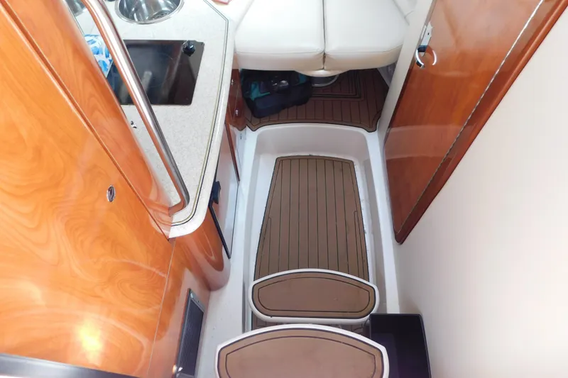 Slide: The Image of Interior of 2006 Fountain 38 LX boat with wood finish and compact kitchenette. - 39