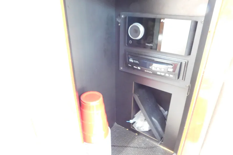 Slide: The Image of 2006 Fountain 38 LX interior with audio system and stacked red cups. - 53