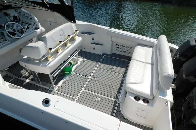Slide: The Image of 2006 Fountain 38 LX boat interior with white seating and modern dashboard. - 10