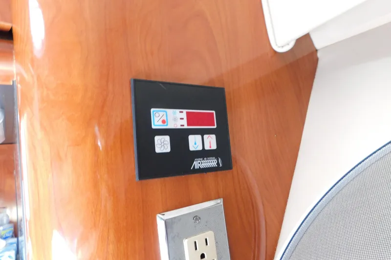 Slide: The Image of Control panel and outlet on 2006 Fountain 38 LX boat interior. - 63