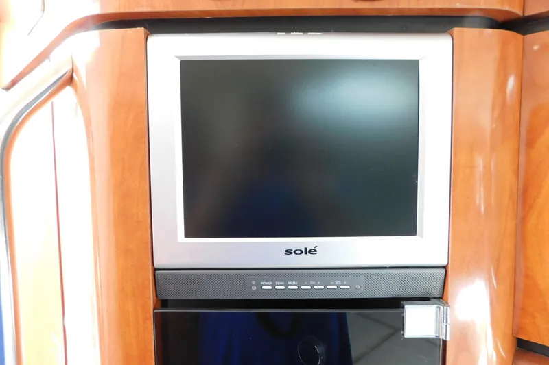 Slide: The Image of Built-in TV screen on 2006 Fountain 38 LX boat interior. - 54