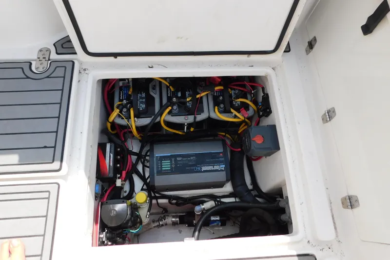 Slide: The Image of 2006 Fountain 38 LX boat battery compartment with wiring and components visible. - 70
