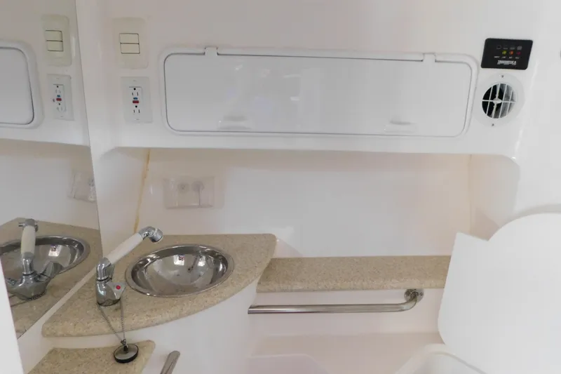 Slide: The Image of Interior of a 2006 Fountain 38 LX boat featuring a compact sink and countertop. - 61