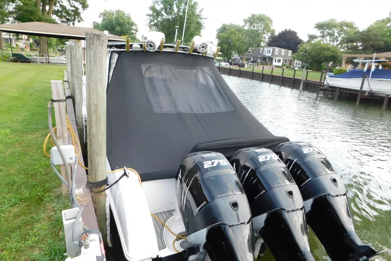 Slide: The Image of 2006 Fountain 38 LX boat docked with triple 275 horsepower engines, covered deck. - 6