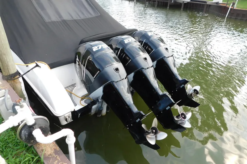 Slide: The Image of 2006 Fountain 38 LX boat with triple Mercury outboard engines docked in water. - 4