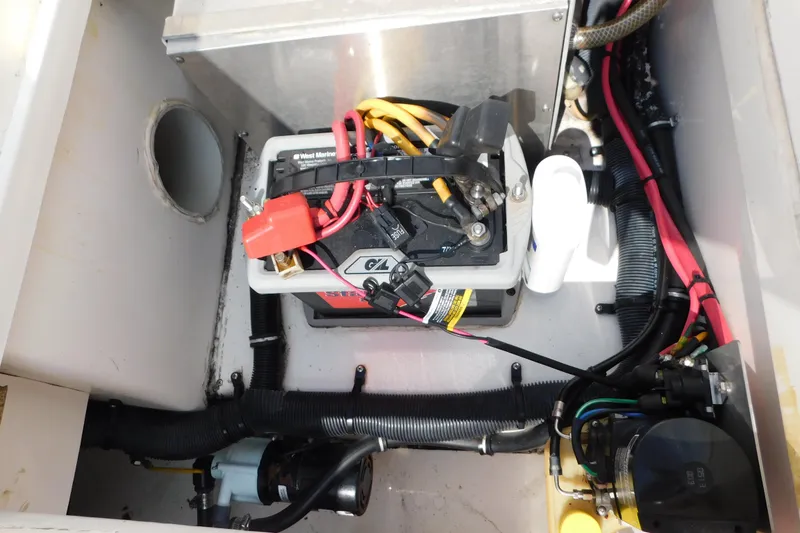 Slide: The Image of Battery compartment of a 2006 Fountain 38 LX boat with wiring and components. - 74