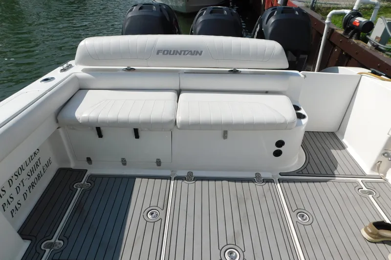 Slide: The Image of 2006 Fountain 38 LX boat interior with cushioned seating and sleek deck design. - 16