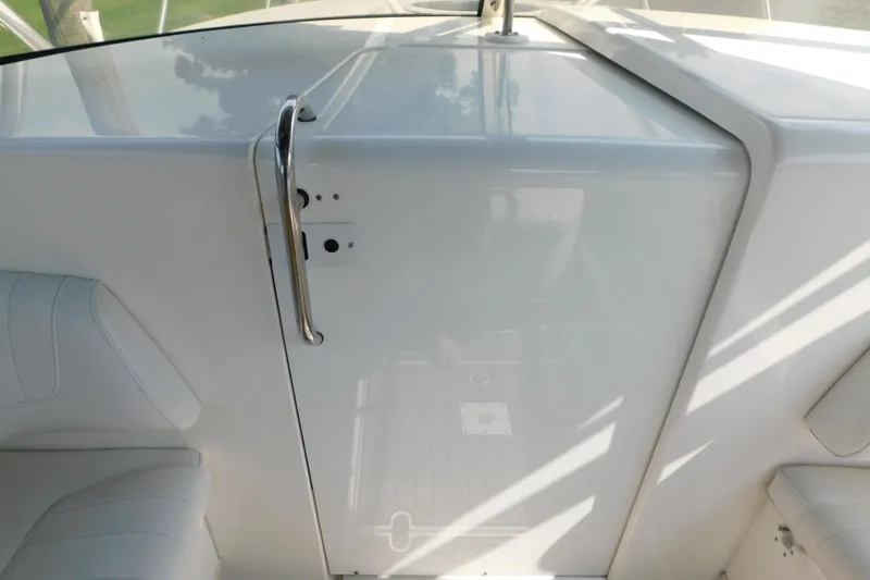 Slide: The Image of 2006 Fountain 38 LX boat interior with white seating and sleek design. - 38