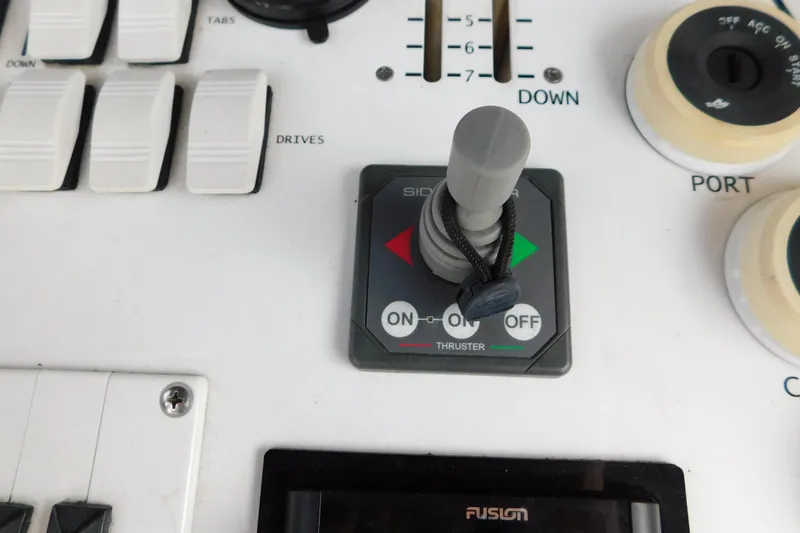 Slide: The Image of Control panel of a 2006 Fountain 38 LX boat with thruster joystick. - 23
