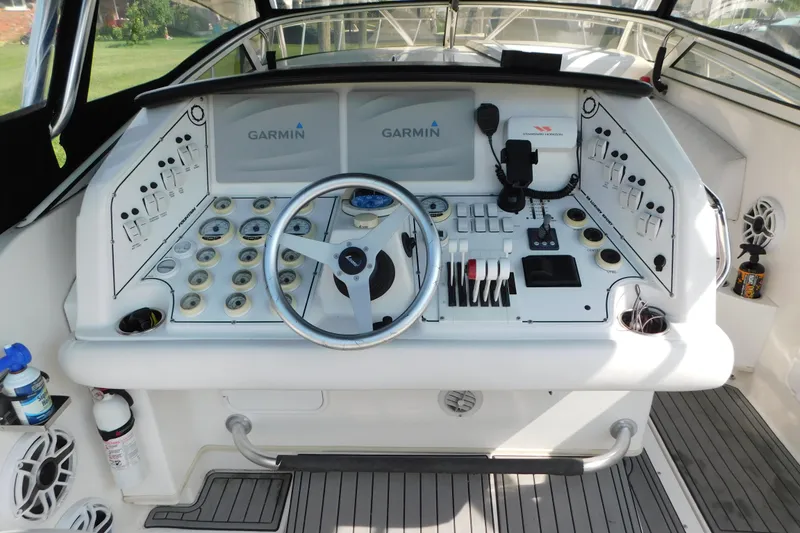 Slide: The Image of Cockpit of 2006 Fountain 38 LX boat with Garmin navigation system and control panel. - 12