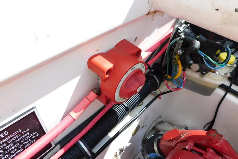 Slide: The Image of 2006 Fountain 38 LX boat engine compartment with wiring and battery switch. - 78