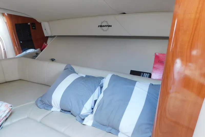 Slide: The Image of Interior cabin of 2006 Fountain 38 LX boat with striped pillows and wood accents. - 43