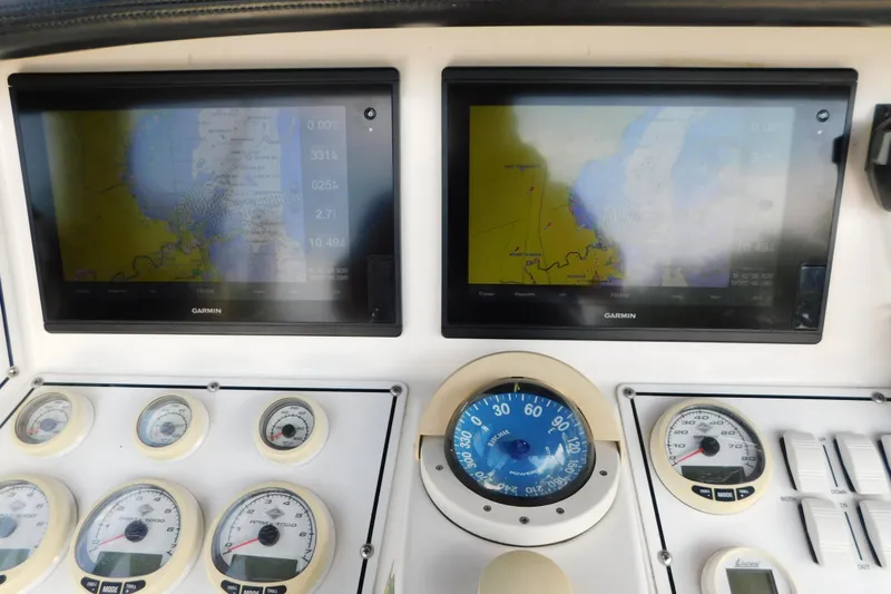 Slide: The Image of Dashboard of a 2006 Fountain 38 LX boat with Garmin navigation displays and gauges. - 20