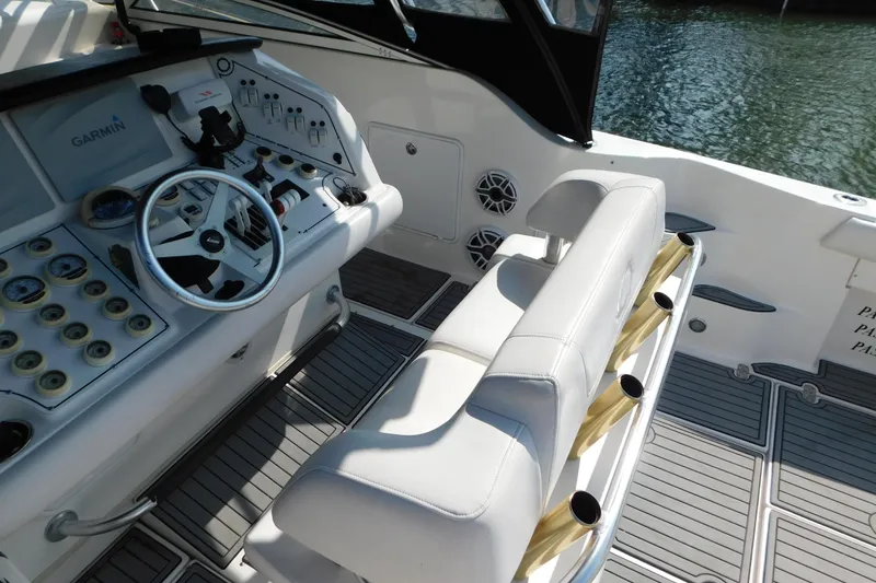 Slide: The Image of 2006 Fountain 38 LX boat cockpit with steering wheel, controls, and seating. - 11