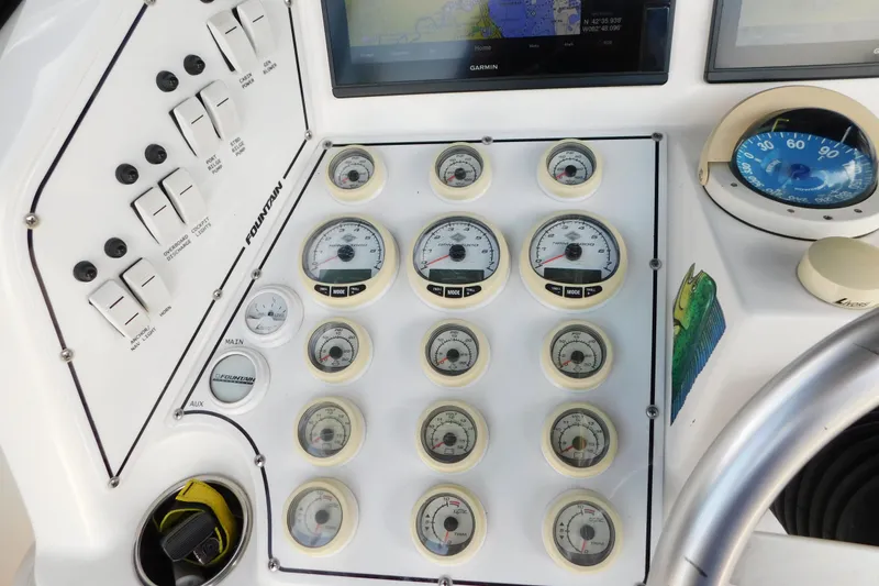 Slide: The Image of Control panel of a 2006 Fountain 38 LX boat with gauges and switches. - 24