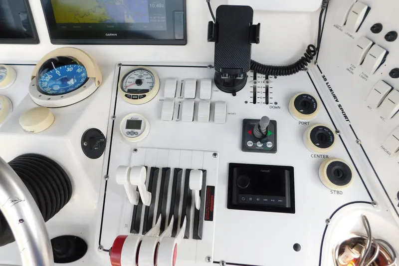 Slide: The Image of Control panel of a 2006 Fountain 38 LX boat with navigation and throttle controls. - 22
