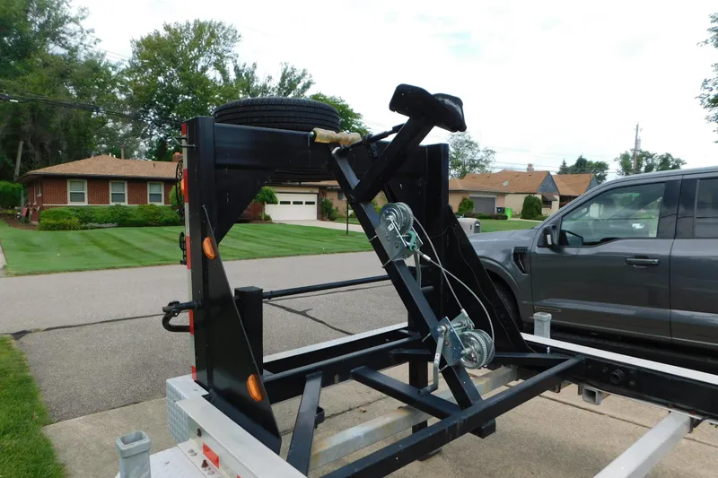 Slide: The Image of Trailer hitch setup for 2006 Fountain 38 LX boat, parked in suburban neighborhood. - 85