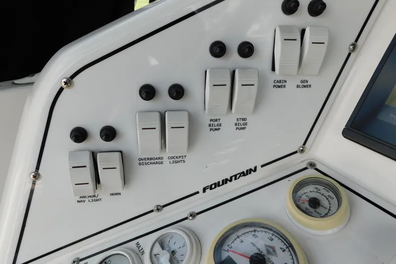 Slide: The Image of Control panel of a 2006 Fountain 38 LX boat with switches and gauges. - 25