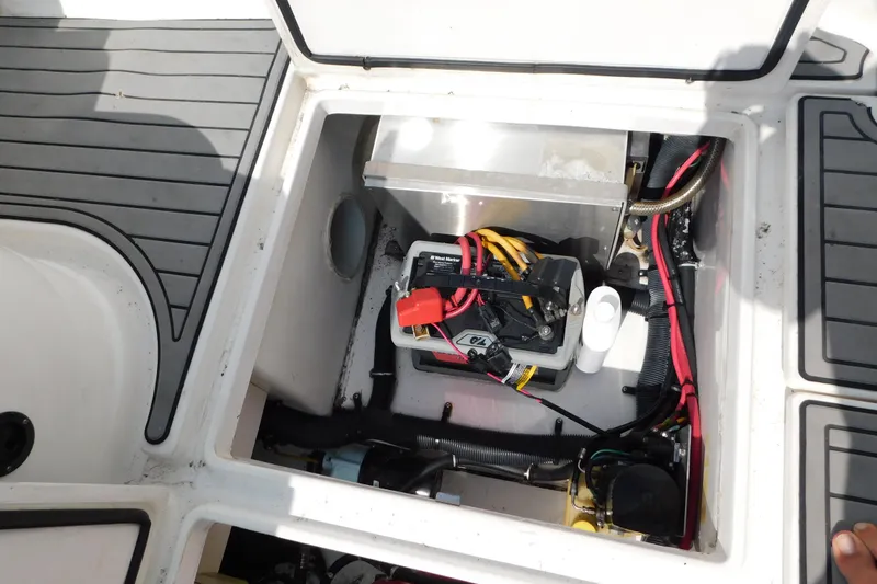 Slide: The Image of Open hatch of 2006 Fountain 38 LX boat showing battery and wiring components. - 73