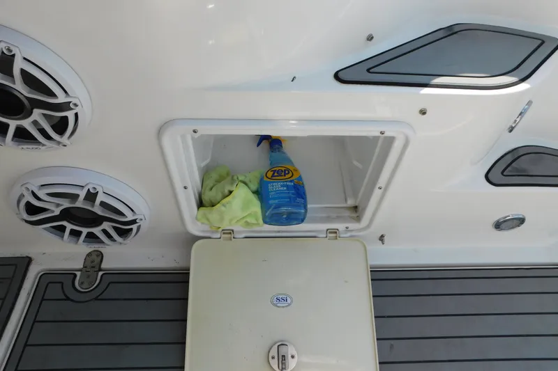Slide: The Image of Storage compartment on 2006 Fountain 38 LX boat with cleaning supplies and speakers. - 18